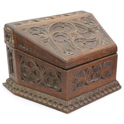 Late Victorian oak stationery box carved with Gothic and foliate panels, hinged sloping lid and divided interior with the trade label of H Ladd, 34 Trinity St. Cambridge, Stationer & Die Sinker W26cm