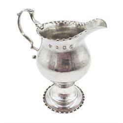 George III silver pedestal cream jug, with acanthus capped scroll handle, the body with lightly hammered and stipple decoration, upon circular foot, hallmarked Ann Smith & Nathaniel Appleton, London 1779, H11cm