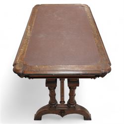 Late 19th century Aesthetic Movement inlaid walnut library table, shaped rectangular top with moulded and banded edge, inset with oxblood leather writing surface, fitted with two frieze drawers, raised on ring turned twin-pillar end supports with carved acanthus capitals terminating to arched supports with ebony inlay, united by turned stretcher 