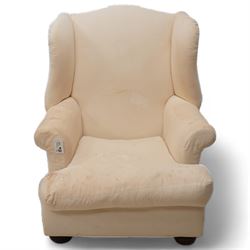 Georgian design mahogany framed wingback armchair, high shaped back over rolled arms with sprung back and seat, on compressed bun feet, upholstered in calico