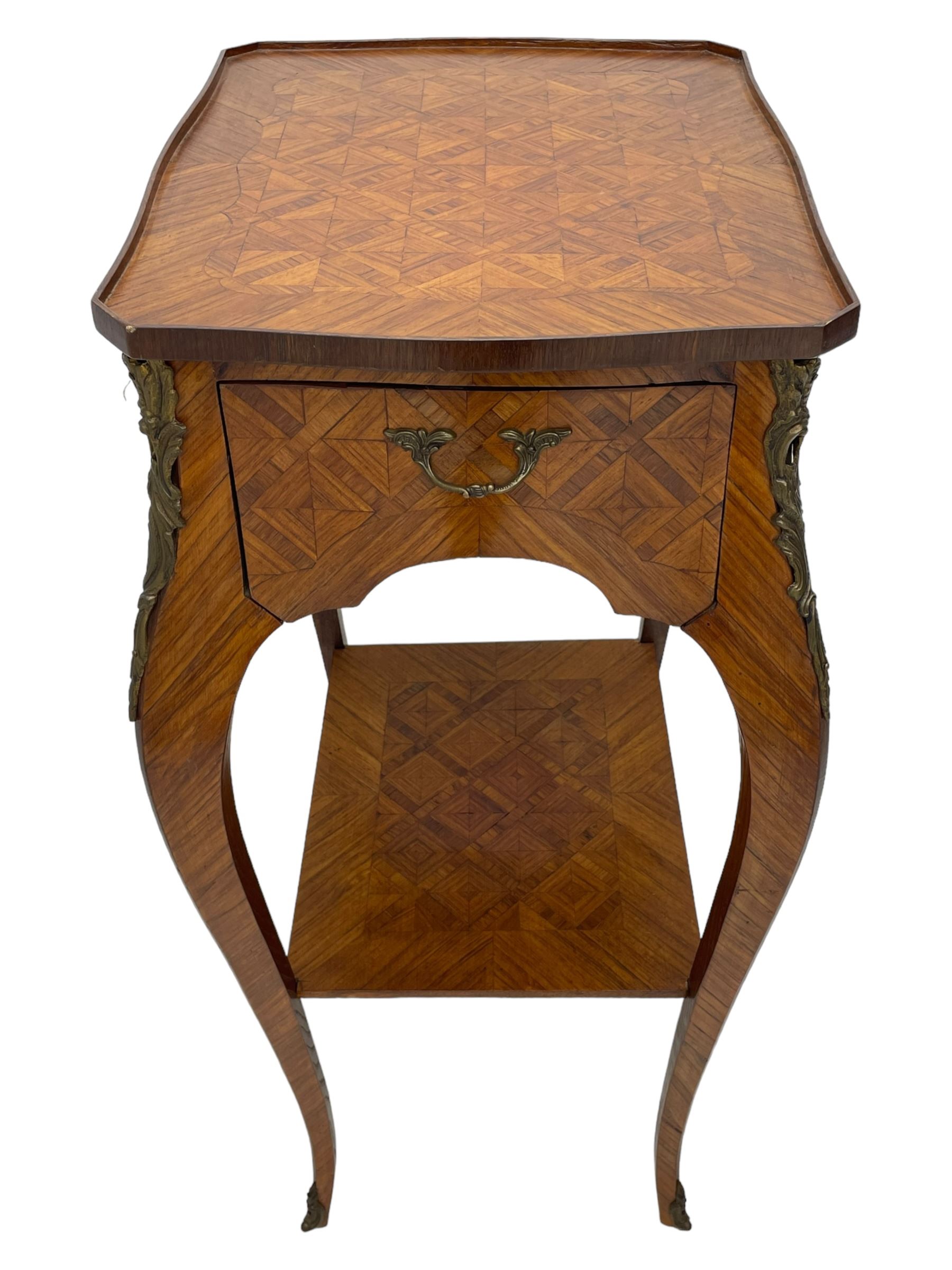 Late 20th century French design Kingwood lamp table, shaped form with geometric parquetry inlaid top within band and raised lip, fitted with single drawer and slide, on cabriole supports united by undertier, decorated with ornate cast gilt metal mounts and terminal caps 