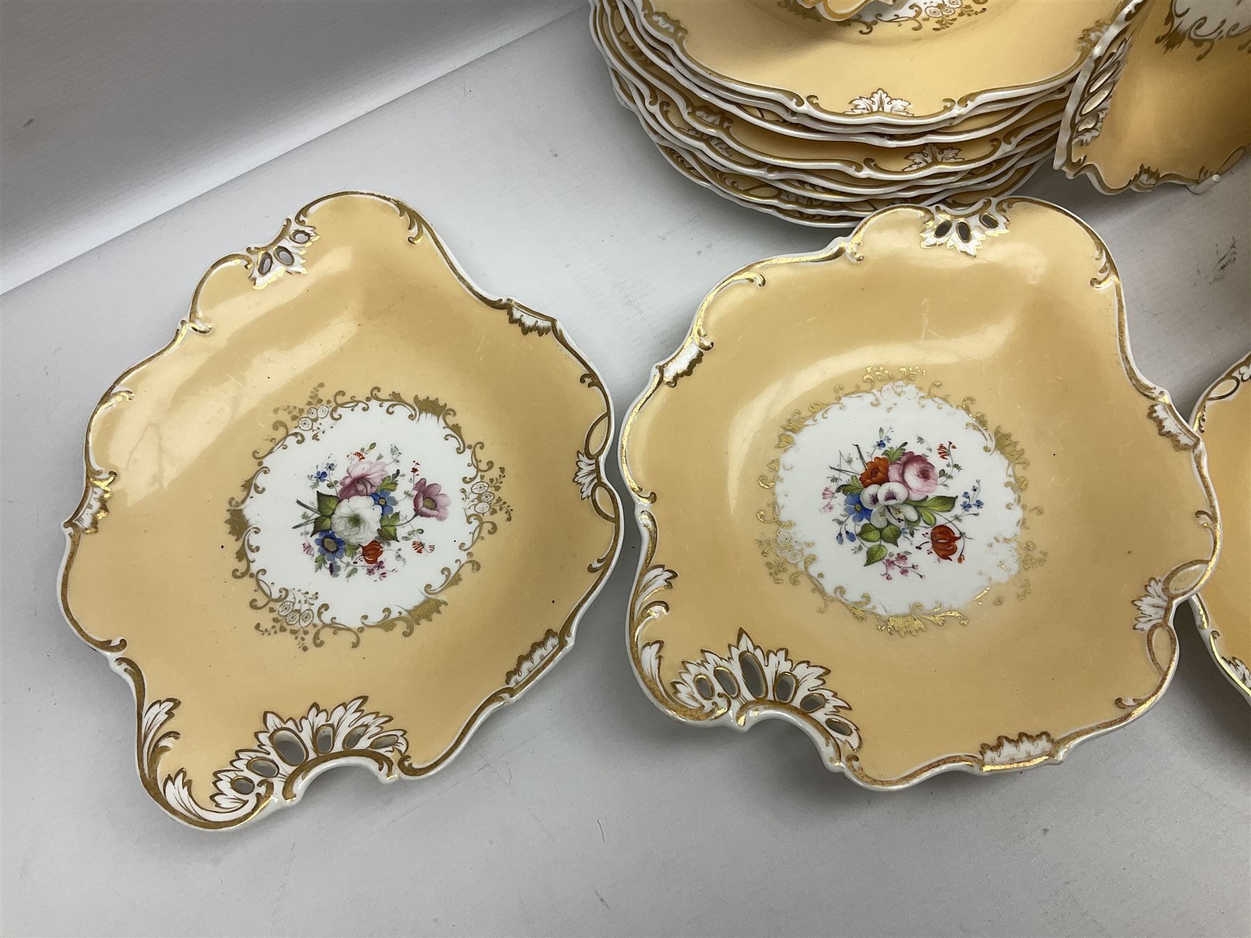 Victorian part dessert service, including eighteen plates, four small serving dishes, shallow dish, etc hand painted with floral sprigs within a cream border with floral panels, and heightened in gilt (26cm)