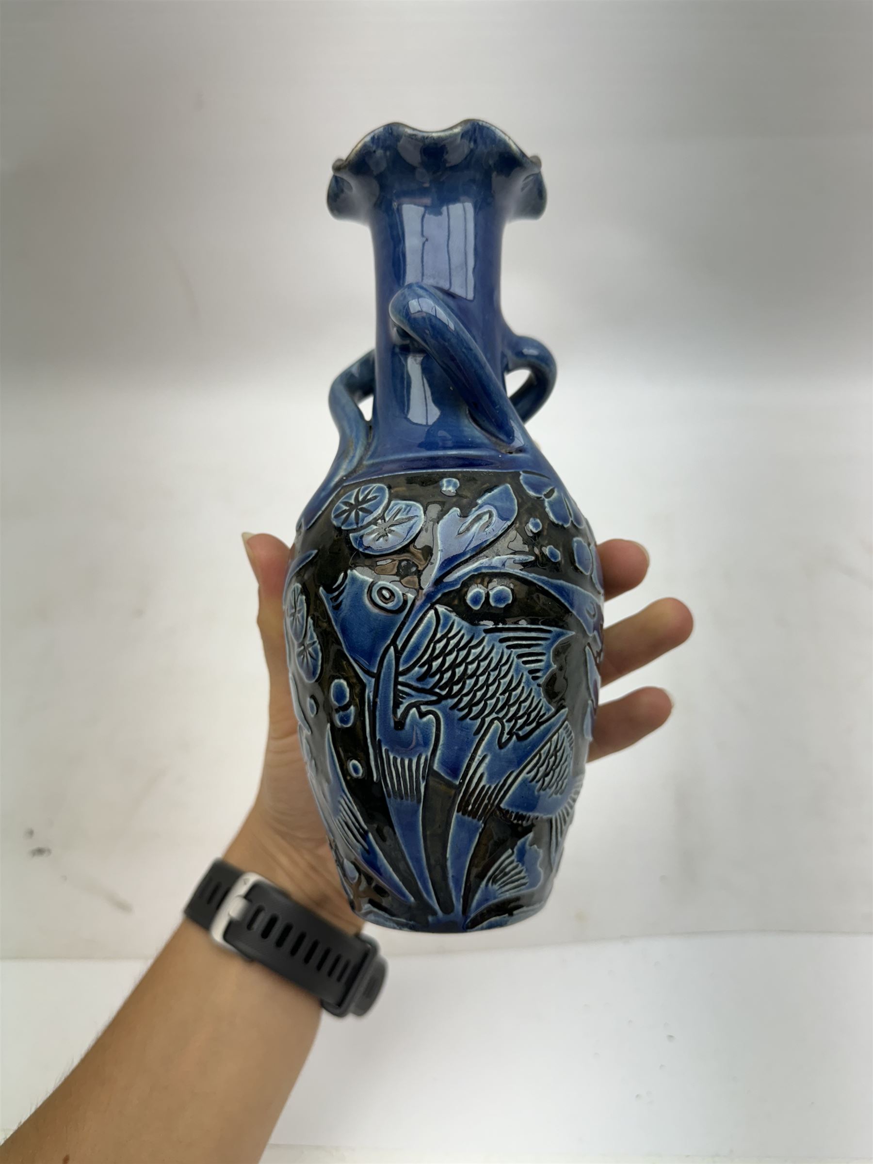 Alexander Lauder for Barum Pottery, vase of baluster form with fluted time, decorated in relief with fish upon a blue ground, H20cm