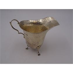 Edwardian silver jug, of helmet form with planished decoration throughout, upon three hoof feet, hallmarked Charles Boyton & Son Ltd, London 1906, H9cm