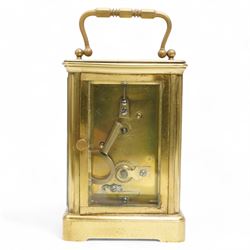 French - Early 20th century 8-day brass carriage clock in a corniche case, with rectangular glazed  panels and an oval viewing glass to the top, enamel dial with raised and gilded decoration in the form of swallows, leaves and flora, contrasting Arabic numerals and steel spade hands, with a cylinder platform escapement, wound and set from the rear. With key.