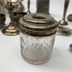 A pair of small silver mounted candlesticks, (a/f), a silver mounted cut glass dressing table jar, silver mounted cut glass atomiser,  further pair of small silver candlesticks and two silver teaspoons (candlesticks and spoons heavily at fault), together with a collection of silver plate, to include a waiter with beaded and shell detailed rim, a pierced and embossed basket, a lobed swing handled dish, teaset comprising teapot, milk jug, jug and twin handled sucrier, pair of twin branch candlesticks, small group of flatware, etc. 