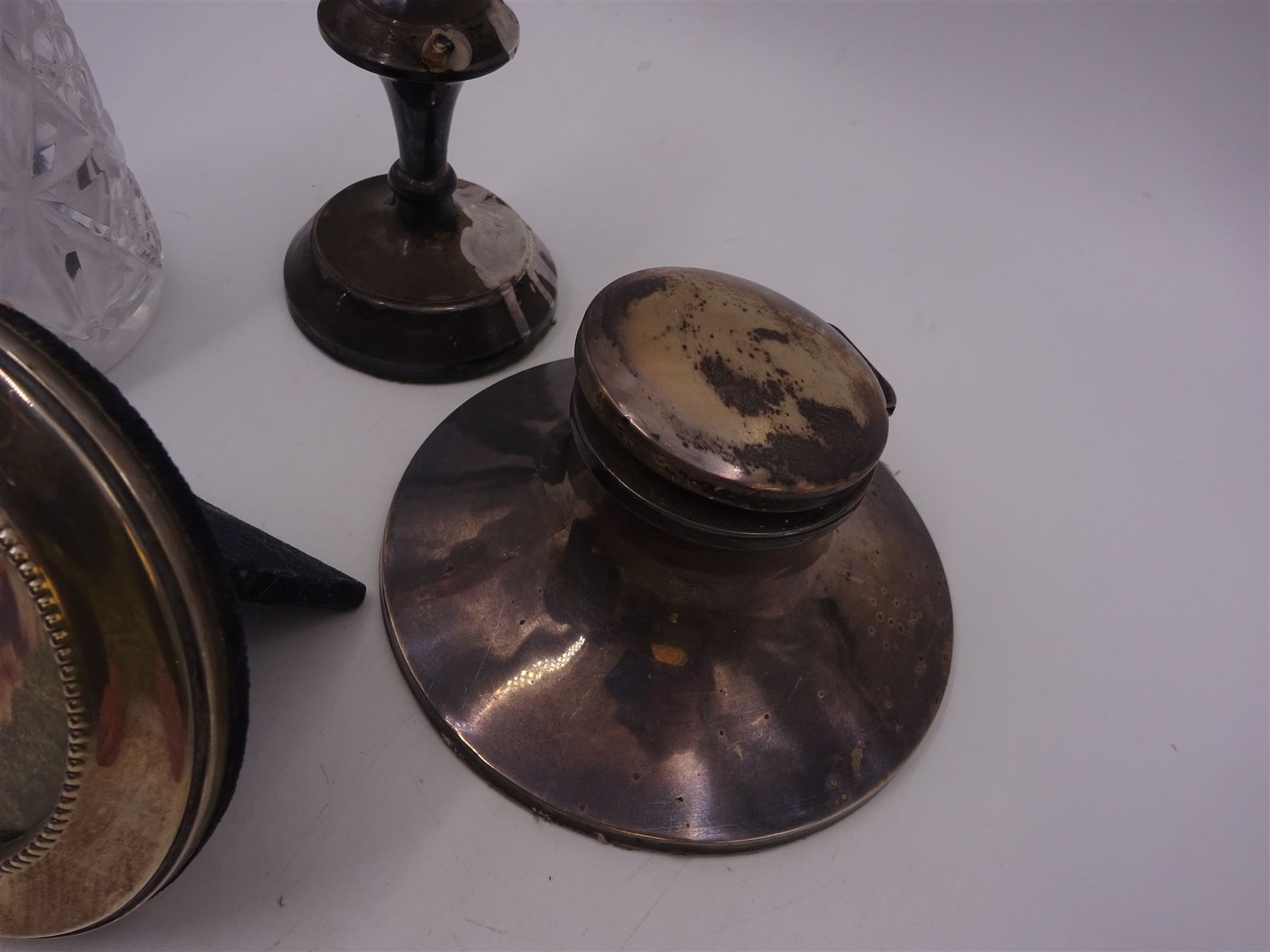 Group of silver mounted items, including cut glass sugar caster, capstan inkwell, circular photograph frame and dwarf candlestick, candlestick H11cm