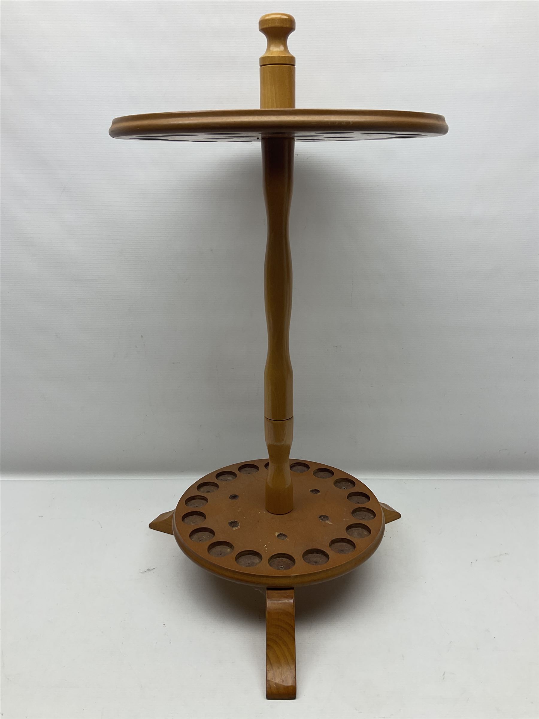 Pine stick stand, with turned central column dividing two circular tiers, upon three feet, with capacity for twenty four walking sticks, H73cm