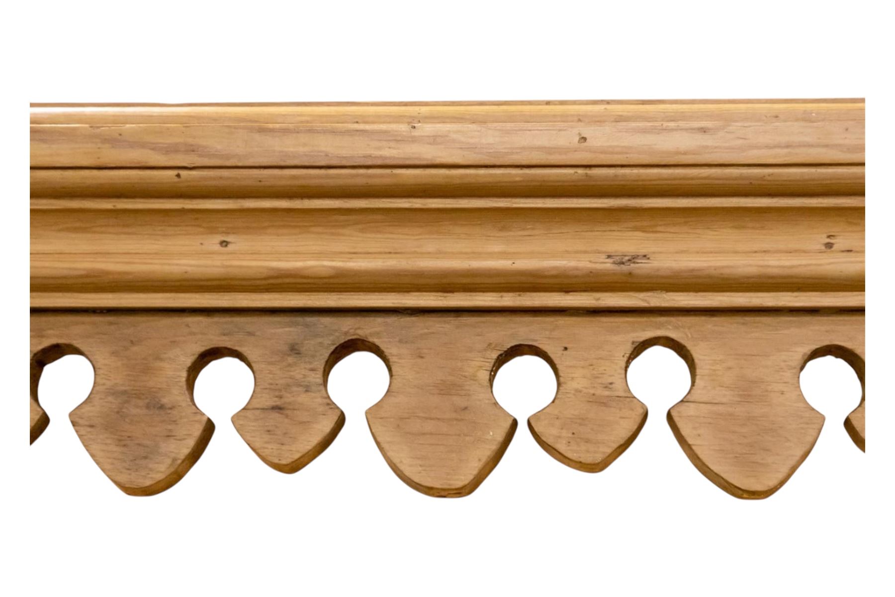 Early to mid-19th century pine cottage dresser, projecting cornice over fretwork frieze, the rack fitted with two shelves over a bank of seven small spice drawers, the base comprising two drawers above an open shelved section