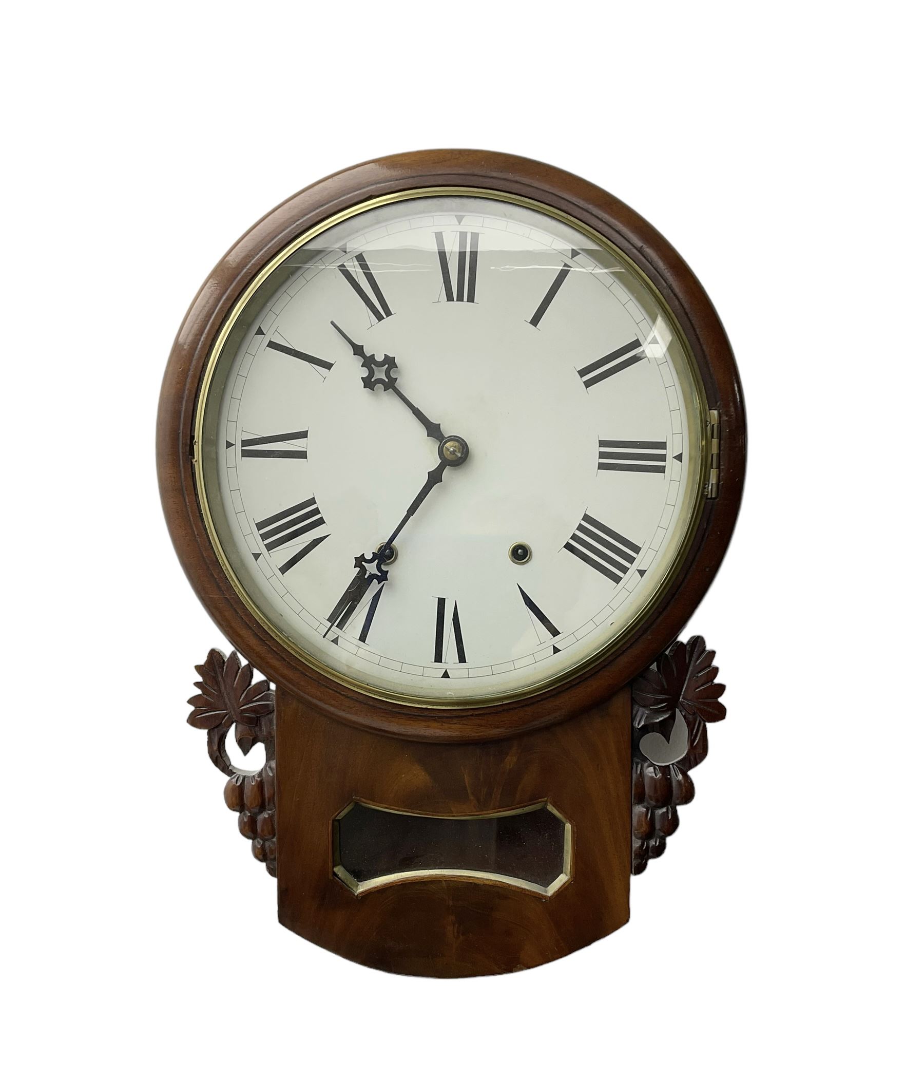 Late 19th century 8-day  drop dial wall clock in a mahogany case, carved ear pieces and glazed pendulum viewing glass, 12” painted dial with Roman numerals and Maltese steel hands, twin train going barrel movement striking the hours on a bell. No pendulum or key.