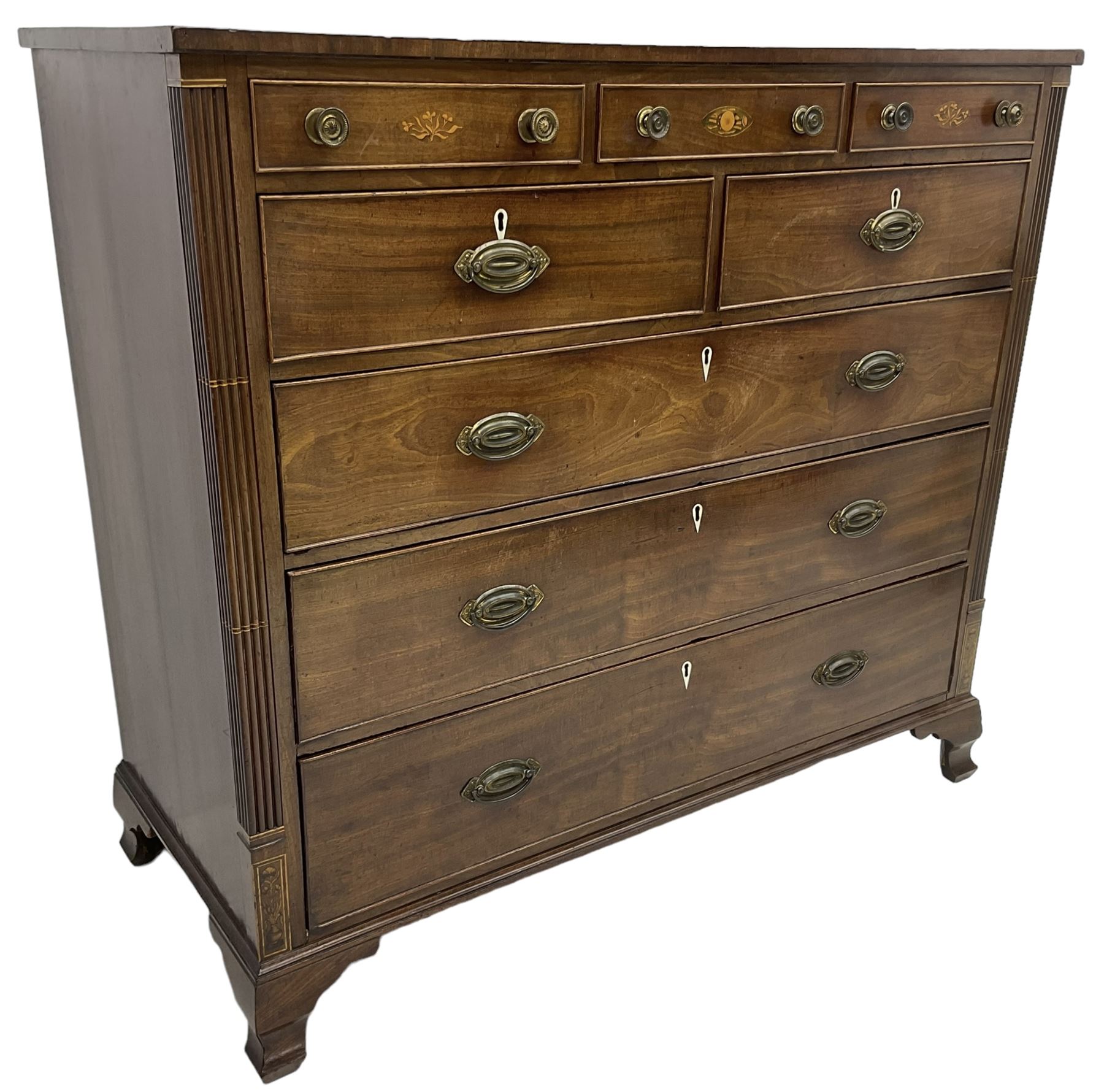 Early 19th century mahogany chest, three shallow frieze drawers over two short and three long cock-beaded drawers, canted corners with reeded moulded square columns, on ogee bracket feet