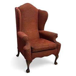 Early 20th century hardwood-framed wingback armchair, upholstered in red dotted fabric, on cabriole feet