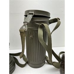 Two WWII German army canteen water bottles, together with German gas mask marked FE55 in a green fluted tin canister