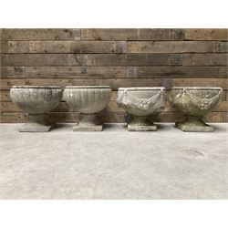 Pair of circular cast stone circular planters, and a similar pair decorated with swags (4)