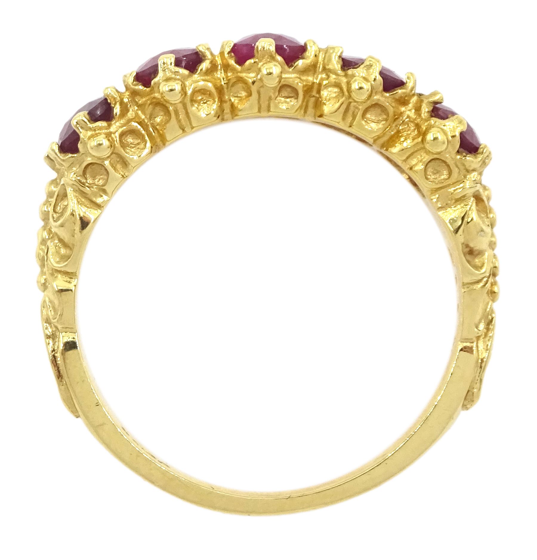 18ct gold five stone oval cut glass-filled ruby ring, with scroll design shoulders, London 2005