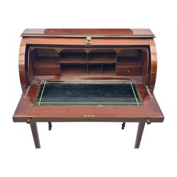 Edwardian inlaid mahogany roll-top desk, cylindrical lid enclosing fitted interior with pigeonholes, drawers and retractable writing surface, over two drawers with brass pull handles, on tapered supports with brass and ceramic castors