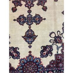 North East Persian Meshed carpet, the field with large central medallion decorated with stylised plant motifs, the field surrounded by panels, medallions and spandrels decorated with floral motifs, indigo ground border with overall floral design 