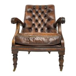 Georgian design mahogany framed library armchair, upholstered in buttoned chocolate brown leather with studwork and loose seat cushion, raised on turned supports with brass castors