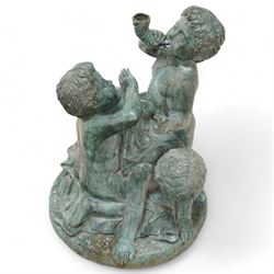 Cast metal garden fountain in the form of three Putti on circular naturalistic base, 