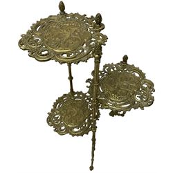 Cast gilt metal three-tier cake stand, each tier decorated with cast foliage scrolls and flower heads with a central bird motif, on turned and fluted supports with splayed C-scroll feet