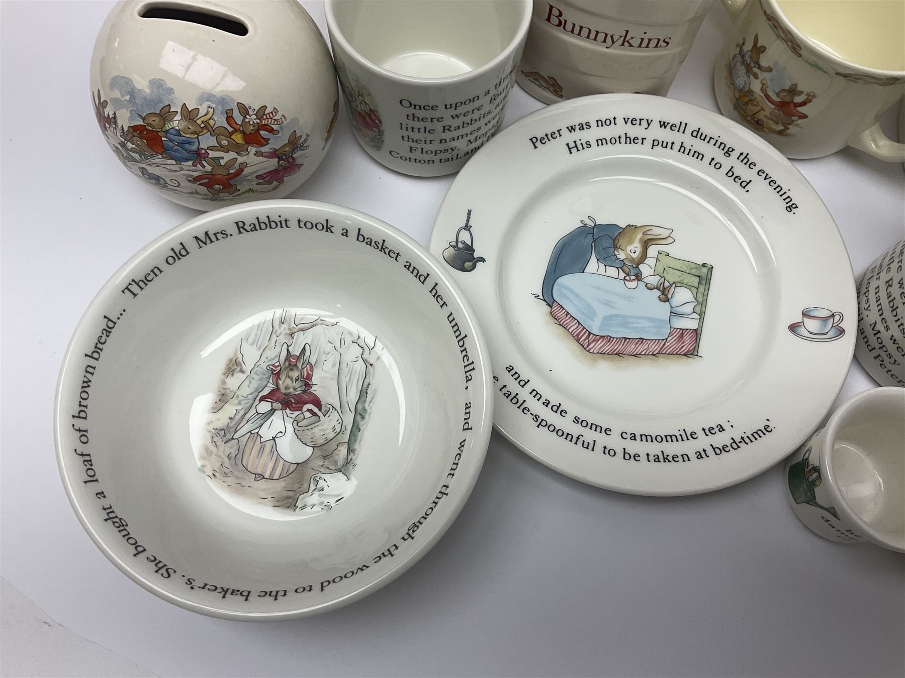 Collection of Royal Doulton Bunnykins and Wedgwood Peter Rabbit nursery ware, including cups, bowls, money boxes, etc 