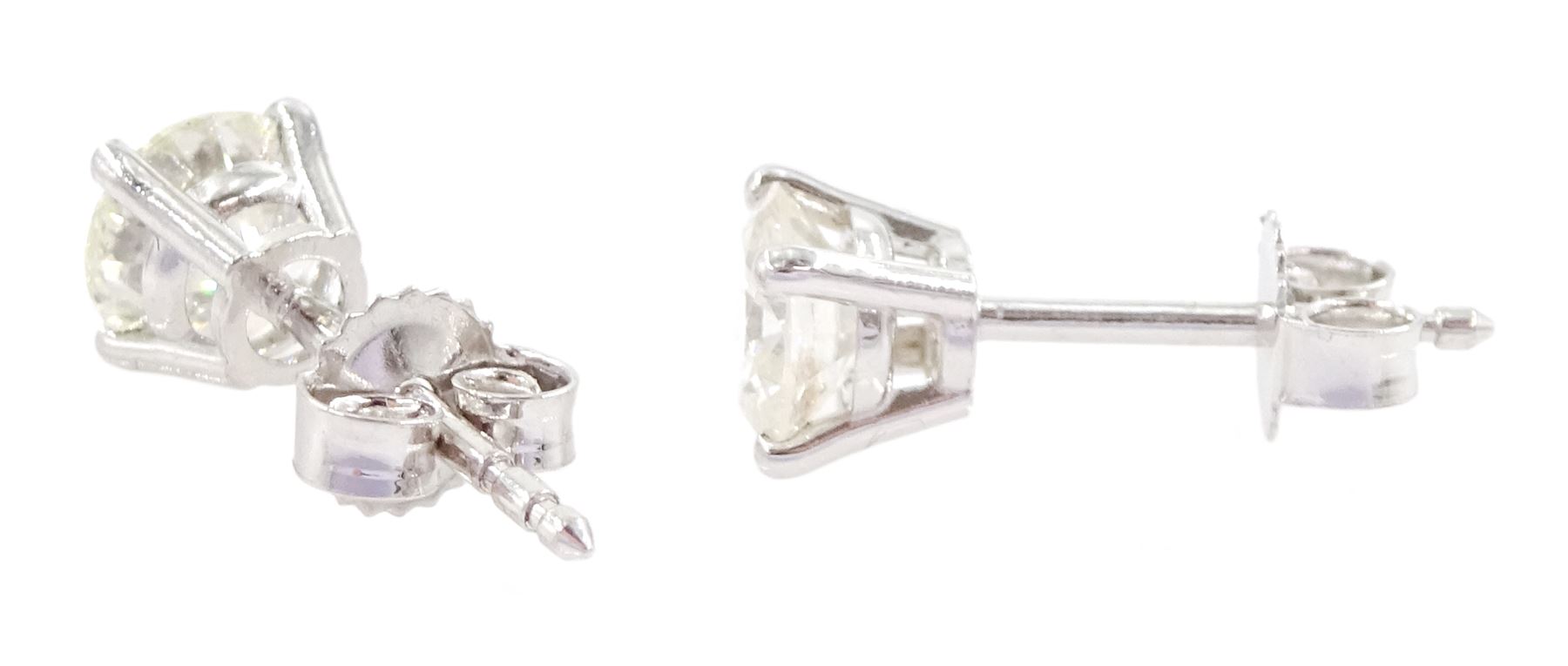 Pair of 18ct white gold round brilliant cut diamond stud earrings, stamped 750, total diamond weight approx 1.05 carat