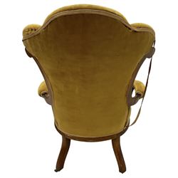 19th century walnut framed open armchair, scallop shaped back with c-scroll uprights, upholstered in yellow buttoned velvet fabric with sprung seat, arm terminals carved with acanthus leaves, raised on scrolling cabriole supports with castors