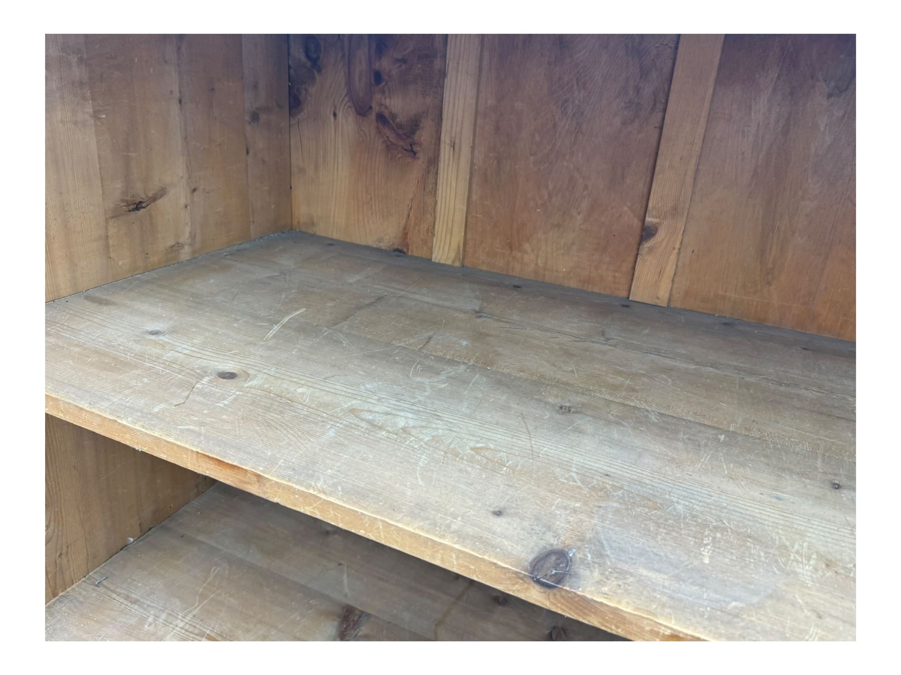 Large 19th century pine cupboard, rectangular top over two panelled later doors, enclosing four open shelves, on plinth base