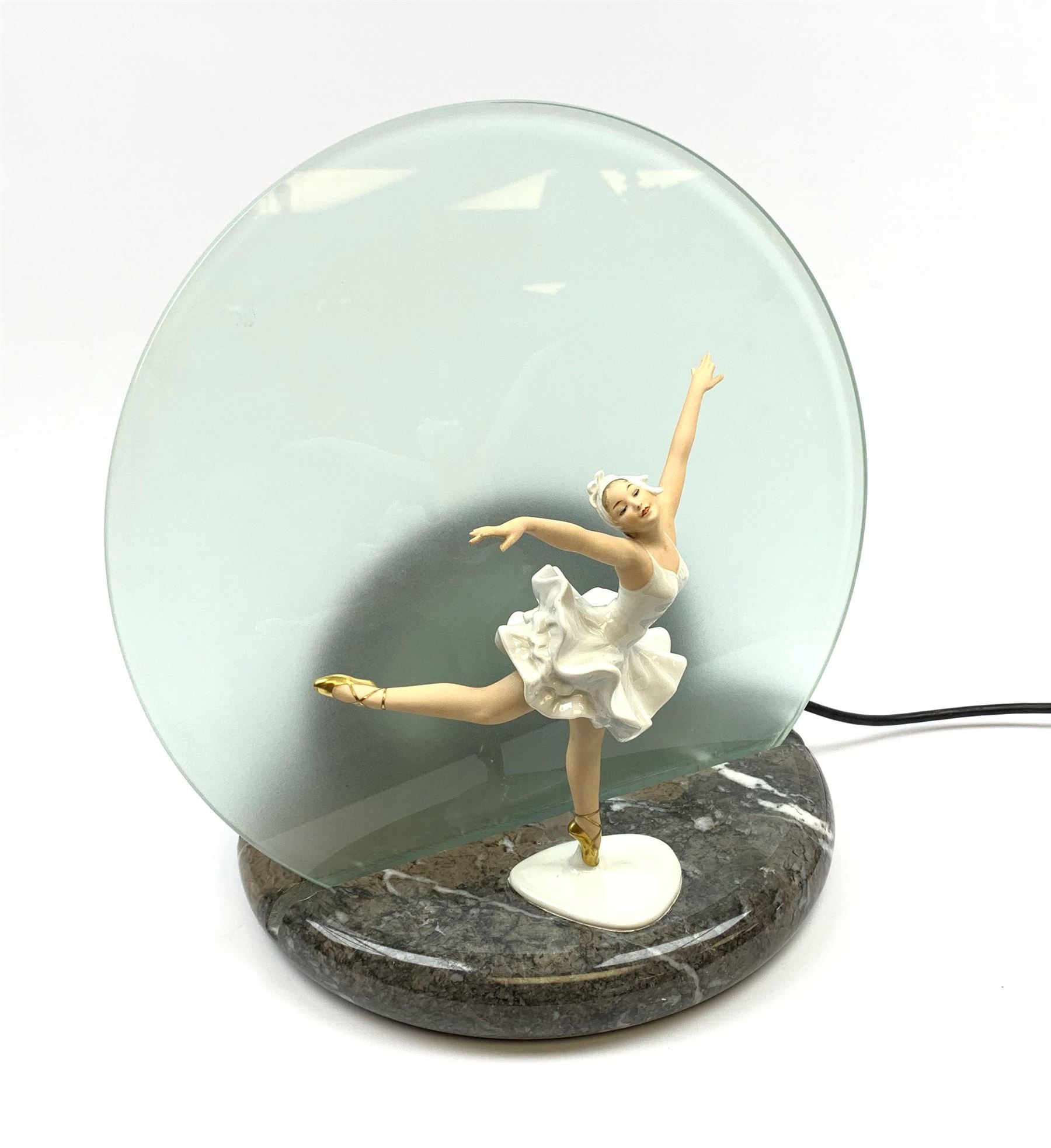 A table lamp with circular frosted glass shade, behind a later mounted continental figure modelled as a ballet dancer, H37cm. 