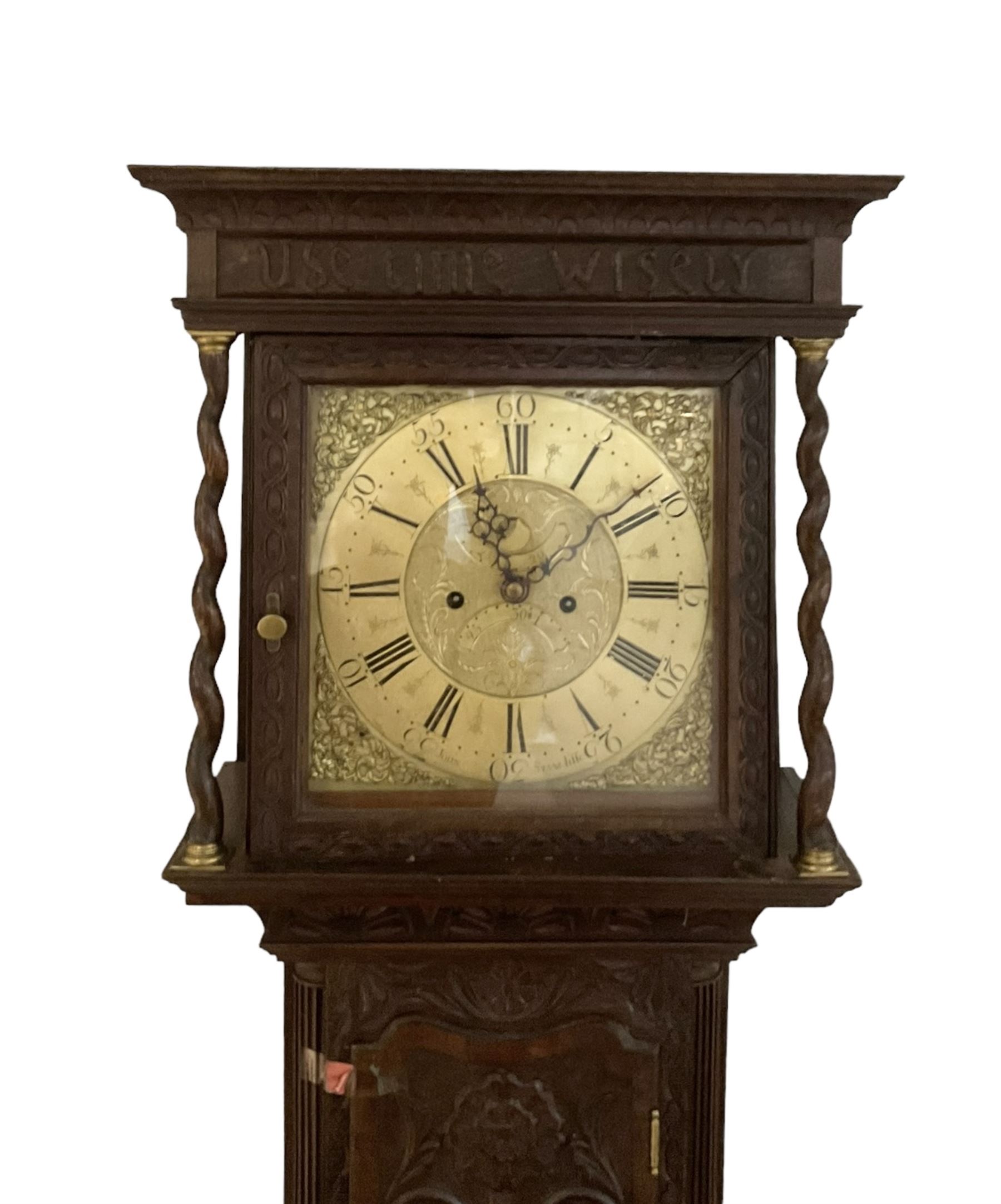 8-day - profusely carved oak longcase, with a flat top and square hood door beneath, door flanked by barley twist columns with brass capitals, trunk with reeded quarter columns and wavy topped door, on a carved plinth raised on bracket feet, brass dial with an engraved and matted dial centre, penny moon and date aperture, chapter ring inscribed “John Stancliffe” with Roman numerals and five-minute Arabic's, rack striking movement with a recoil anchor escapement. With pendulum and weights.