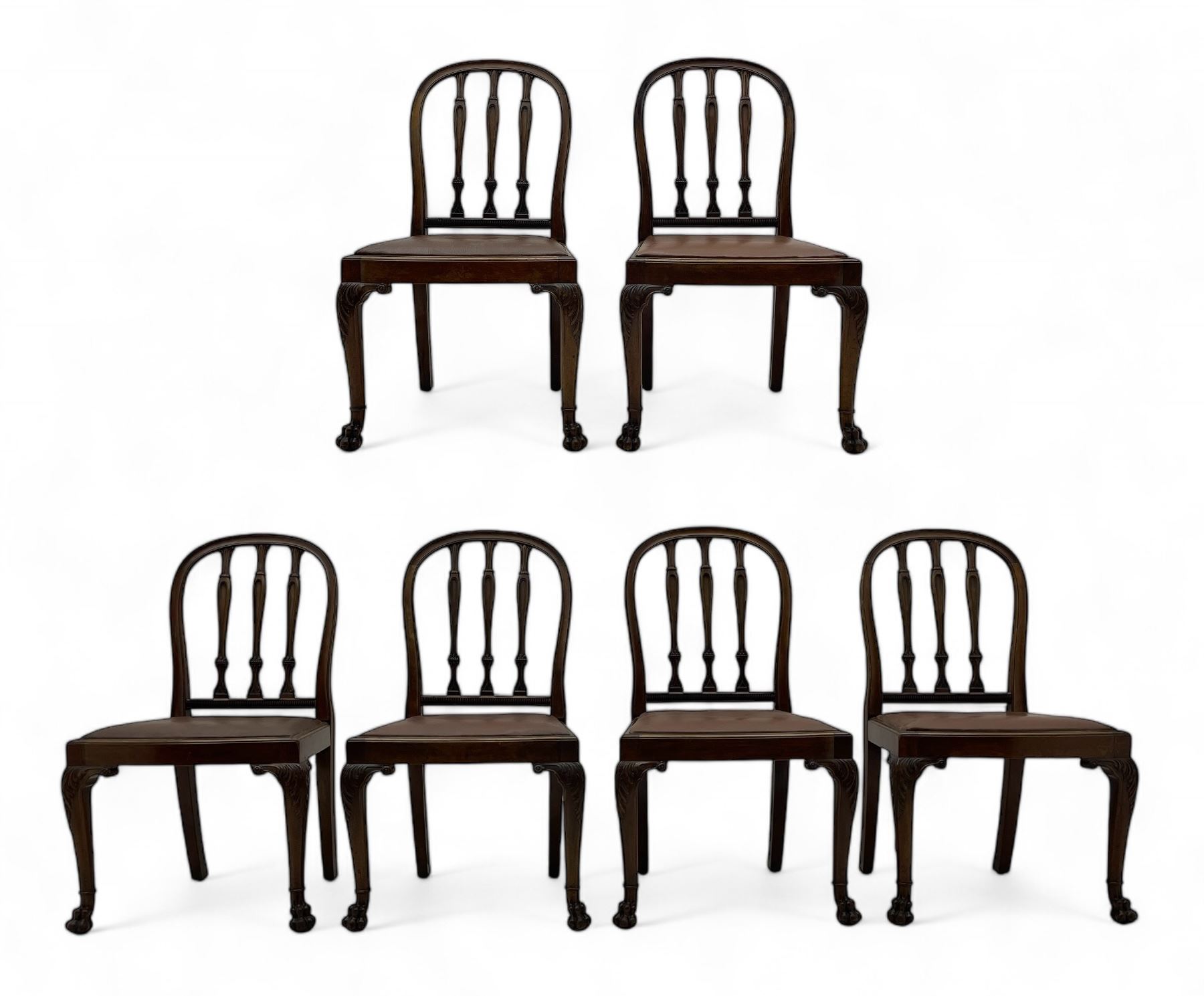 Set of six early 20th century Hepplewhite design mahogany dining chairs, moulded arched frame back, three shaped vertical rails carved with stylised foliate decoration, drop-in seats upholstered in brown fabric within moulded seat rails, on acanthus leaf carved cabriole supports with paw carved terminals 