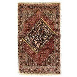 Persian Bidjar peach ground rug, the field decorated with repeating Herati motifs surround...