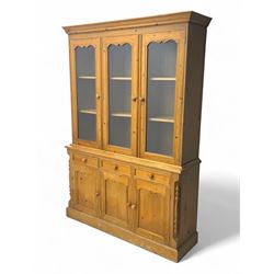 Pine dresser, three raised display cabinets over drawers and cupboards 