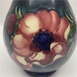 Moorcroft Anemone pattern vase of baluster form, upon a blue ground, with painted and impressed marks beneath, H24cm