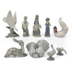 Seven Lladro figures including group of two doves, rooster, boy with accordion, deer, dove in flight , two geese and two Nao figures