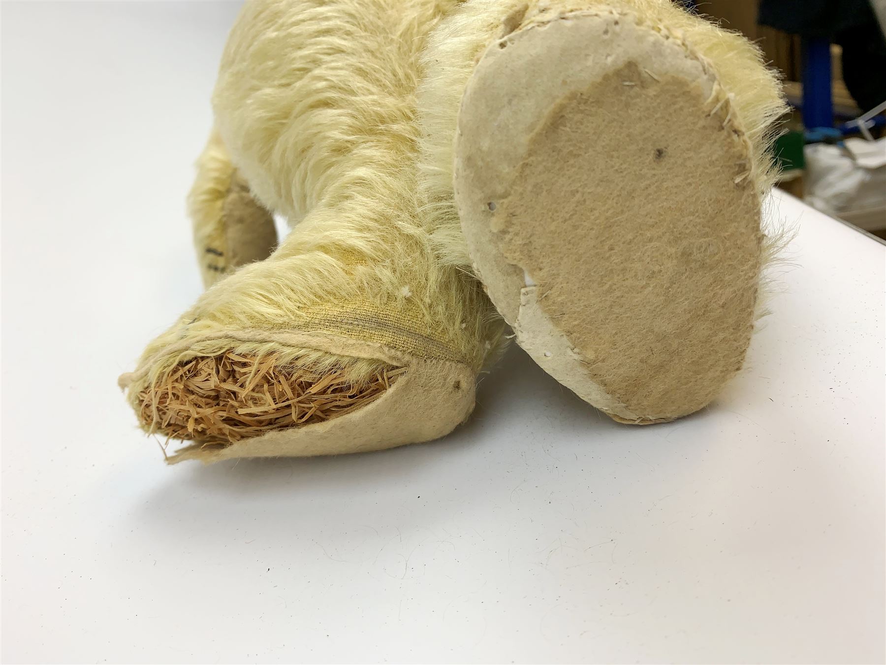 Chad Valley large teddy bear c1930s with wood wool filled blond mohair body, jointed swivel head with glass eyes, shaved muzzle with vertically stitched nose and mouth and jointed limbs H21