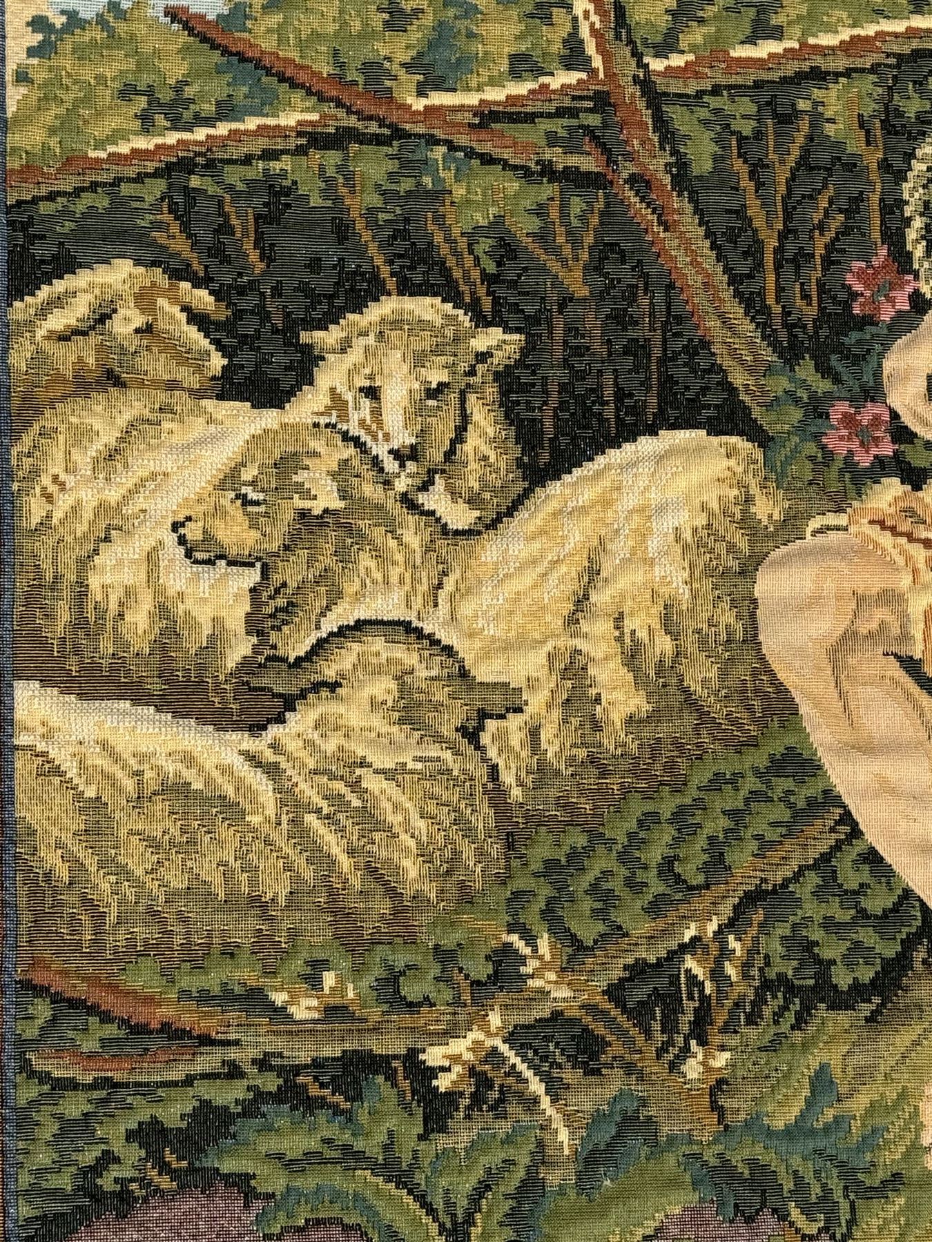 French machine woven tapestry, the scene depicting pastoral life with shepherds and sheep against a backdrop of lush foliage and classical architecture, bordered by a floral and scroll design