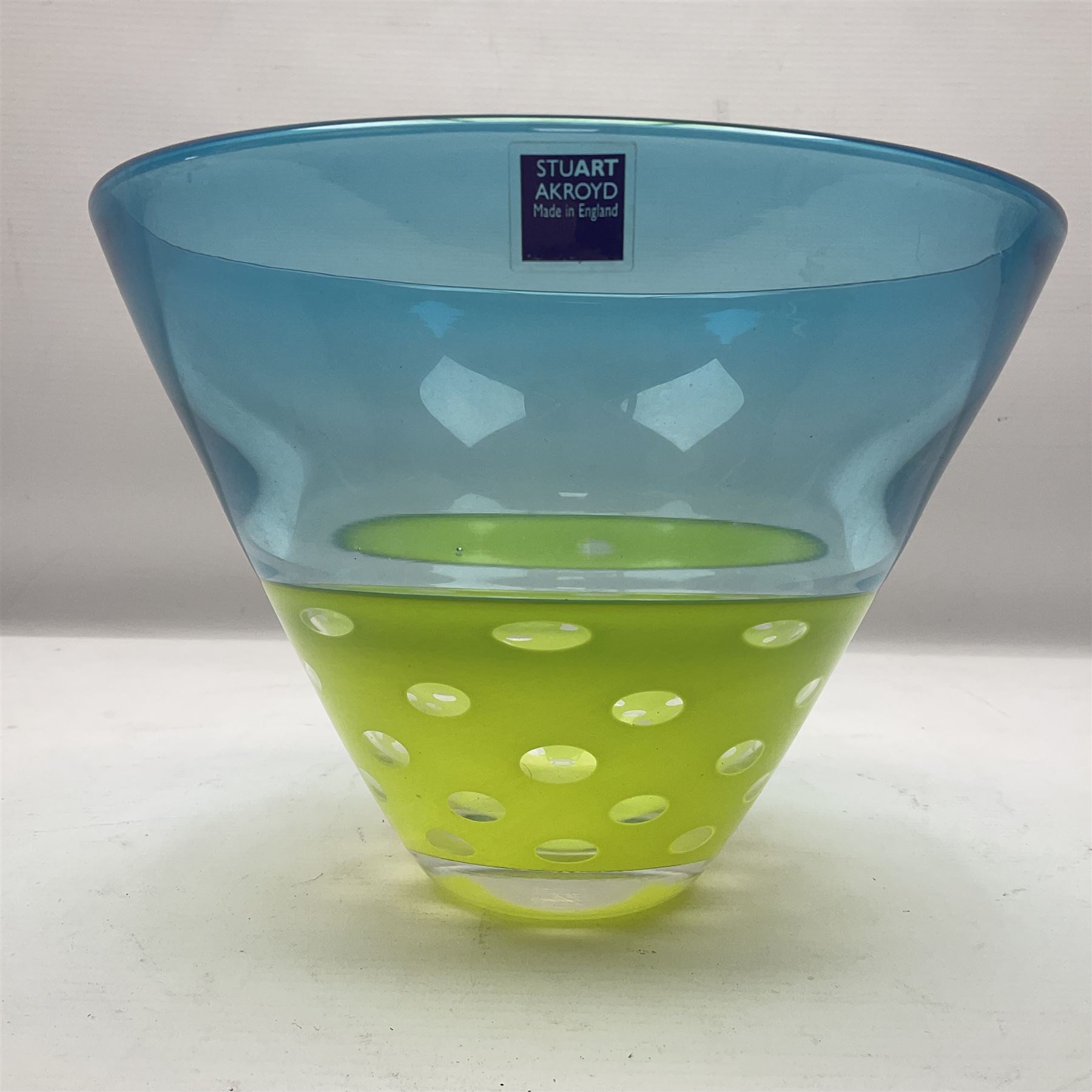 Stuart Akroyd glass vase, blue banded top and lime green opaque lower section with bubble inclusions, with sticker and engraved signature beneath, H15cm