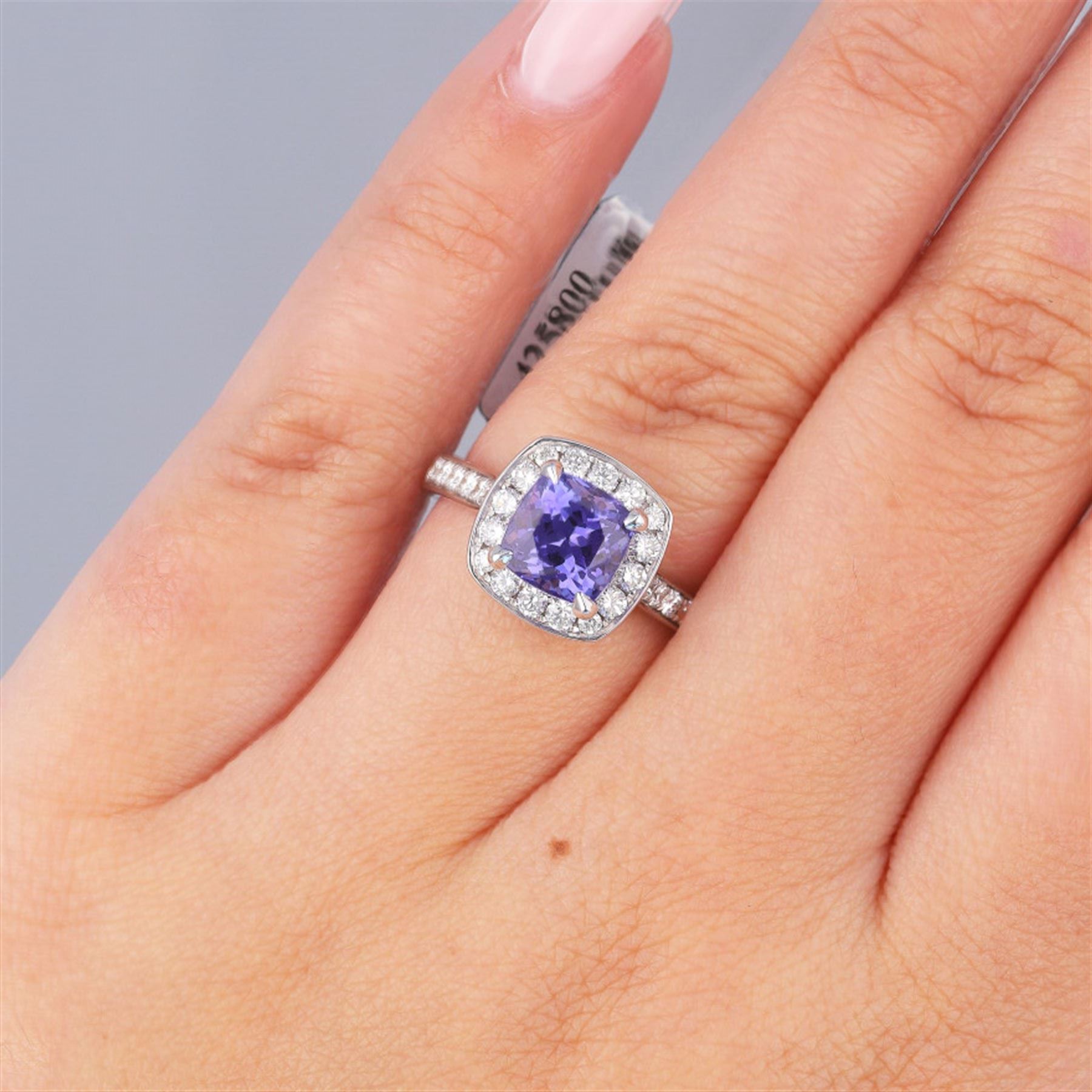 18ct white gold cushion cut tanzanite and round brilliant cut diamond cluster ring, with diamond set shoulders, hallmarked, tanzanite 2.25 carat, total diamond weight approx 0.55 carat