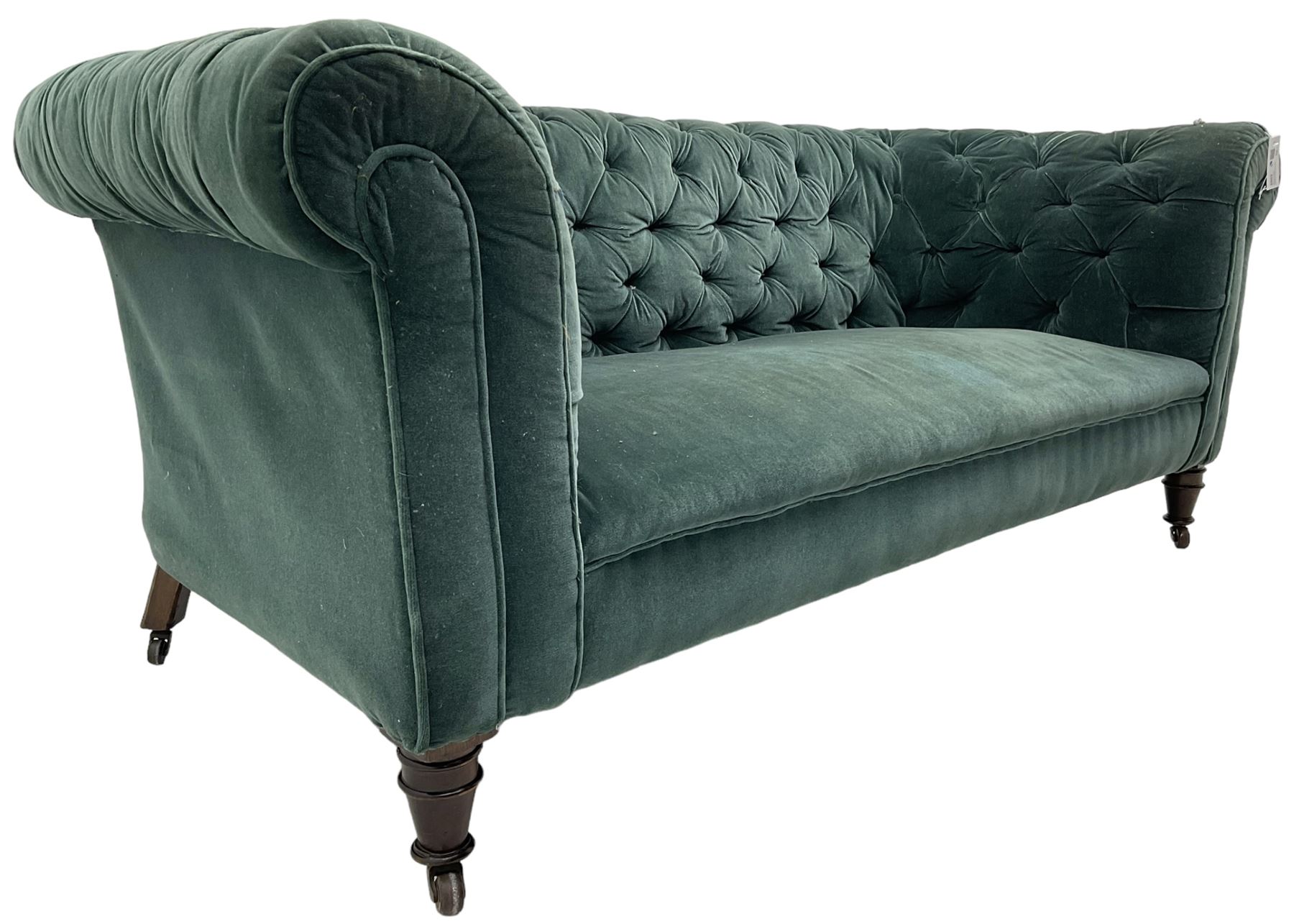 Victorian hardwood-framed Chesterfield sofa, traditional shape with low back and rolled arms, upholstered in teal buttoned fabric, on turned front feet with brass and ceramic castors 