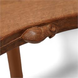 Mouseman - oak three-legged stool, dished kidney-shaped seat on three octagonal splayed supports, carved with mouse signature, by the workshop of Robert Thompson, Kilburn