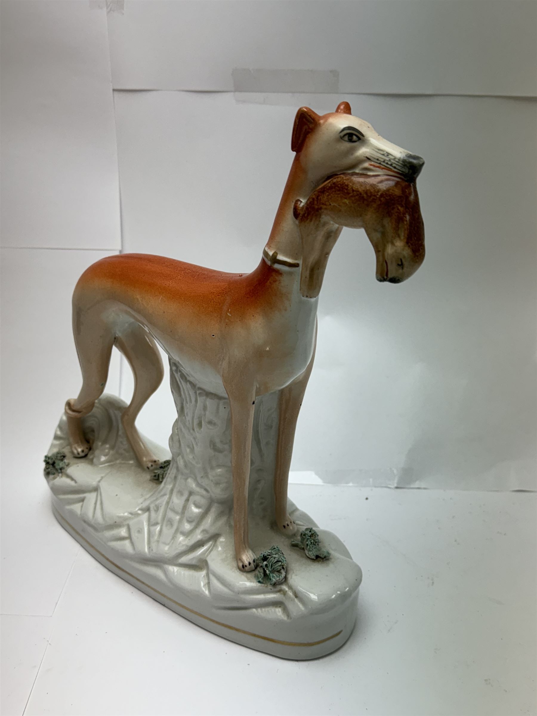 Pair of standing Staffordshire whippets with rabbits in their mouths, together with a pair of Staffordshire spaniels, whippets H30cm