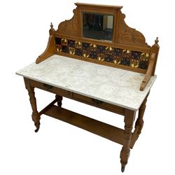 Late Victorian satin walnut washstand, raised bevelled mirror and tiled back carved with scrolled foliage, white marble rectangular top over two drawers, on collar turned supports joined by under-tier 