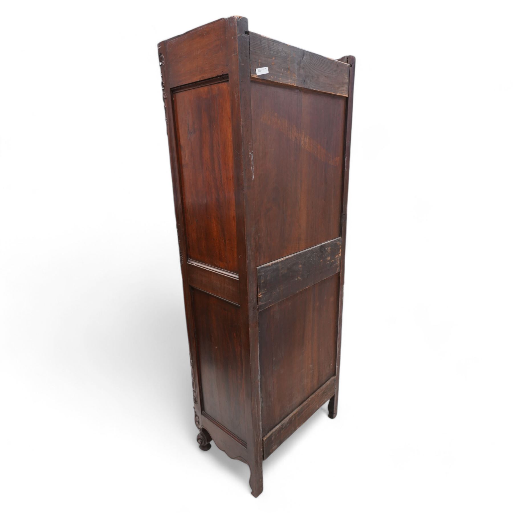 19th century French walnut hall cupboard, the frieze carved with a bouquet of flowers and trailing foliate decoration, enclosed by single panelled door over single drawer, the curved outer corners decorated with trailing leafy branches and flower heads, shaped apron with scroll carved cabriole feet 