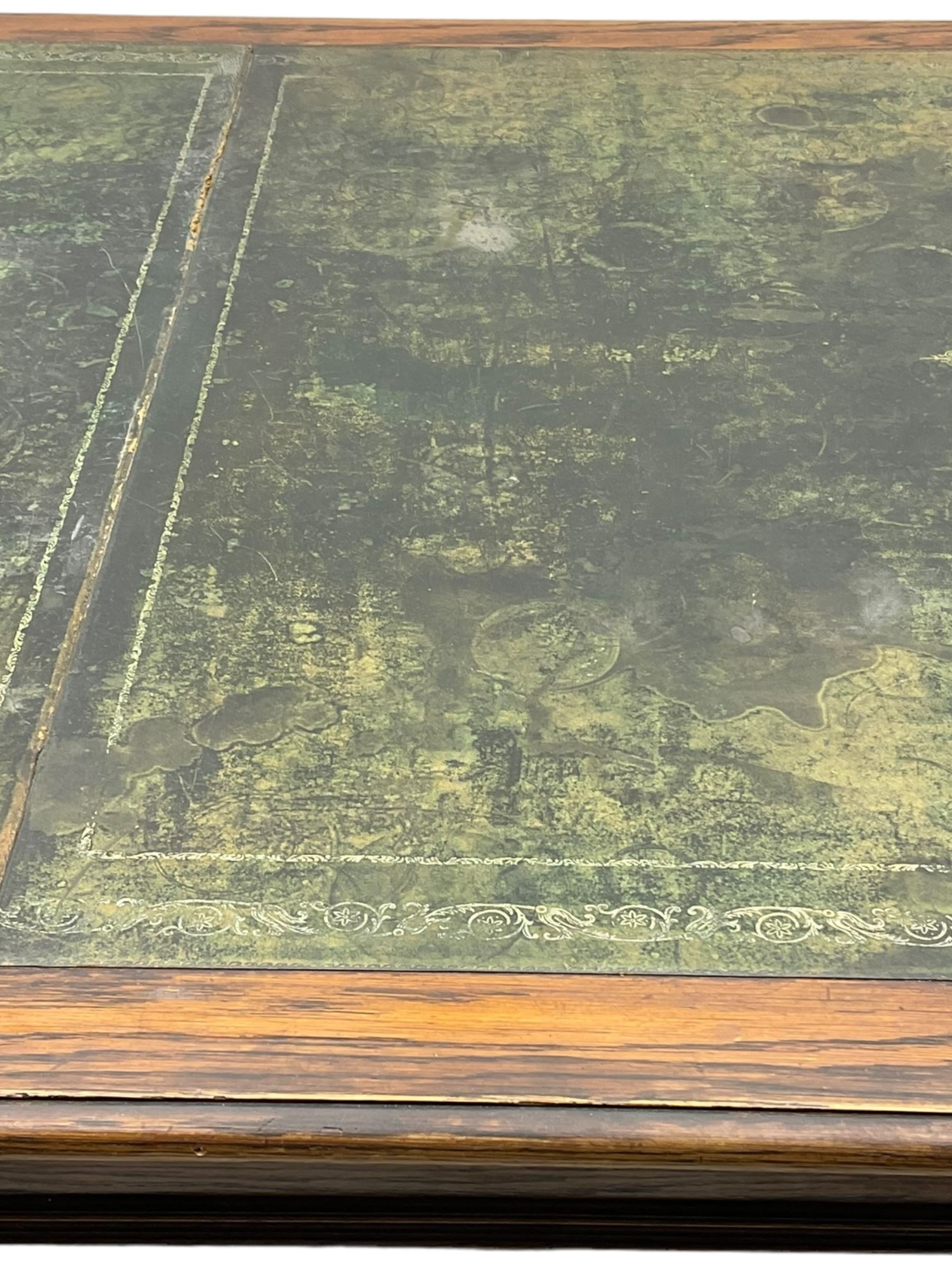 Large 10' 7'' late Victorian oak boardroom table, moulded rectangular top with inset green leather surface, on turned and reed moulded supports with brass and ceramic castors 