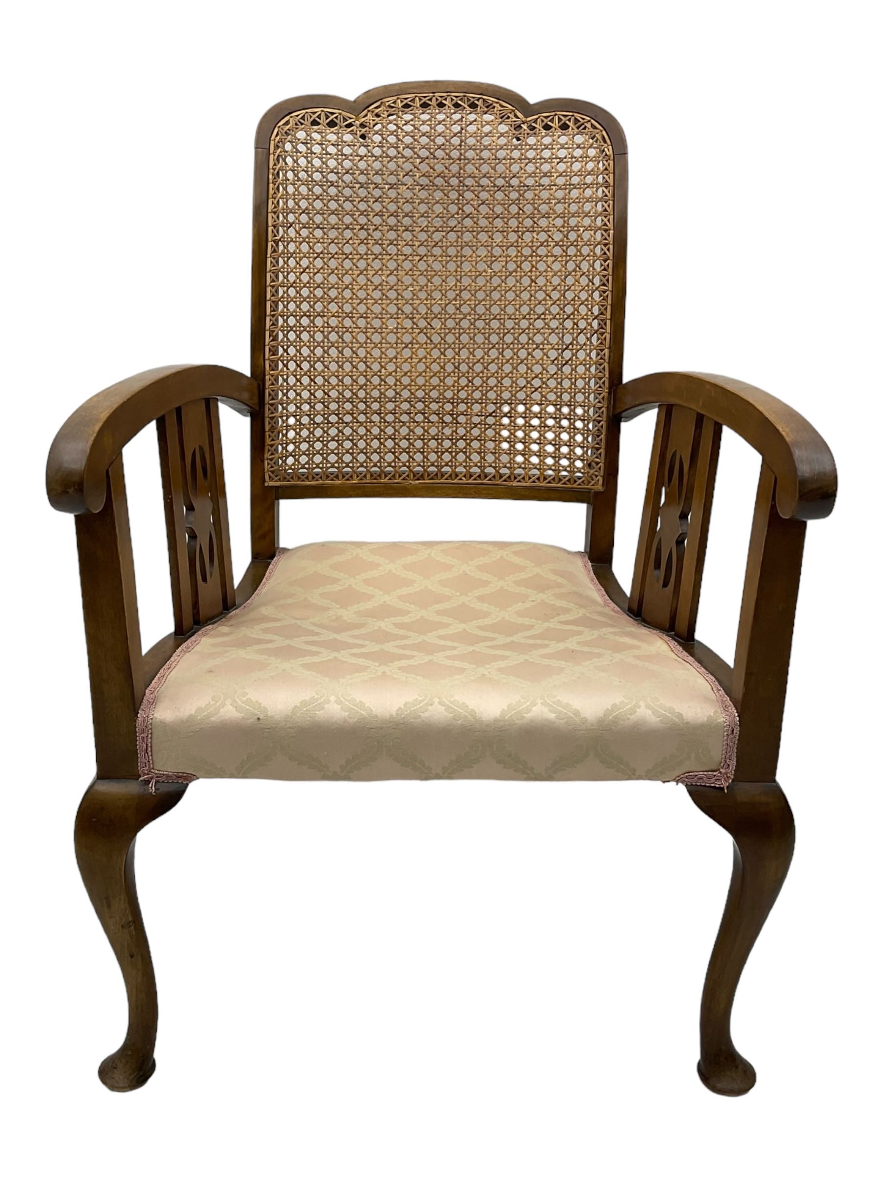 Early 20th century beech framed chair, with scalloped caned backrest, curved arms with pierced splats, upholstered seat in light pink fabric with gold trim, on cabriole supports