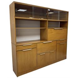 Mid-20th century teak sectional wall unit, combination of cupboards and drawers, raised sliding glass doors