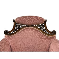 Late 19th century carved walnut framed armchair, the upper spandrels pierced and carved with curled acanthus leaves, upholstered in pink foliate pattern fabric, acanthus leaf carved and scrolled arm facias terminating to cabriole supports, leaf carved terminals 