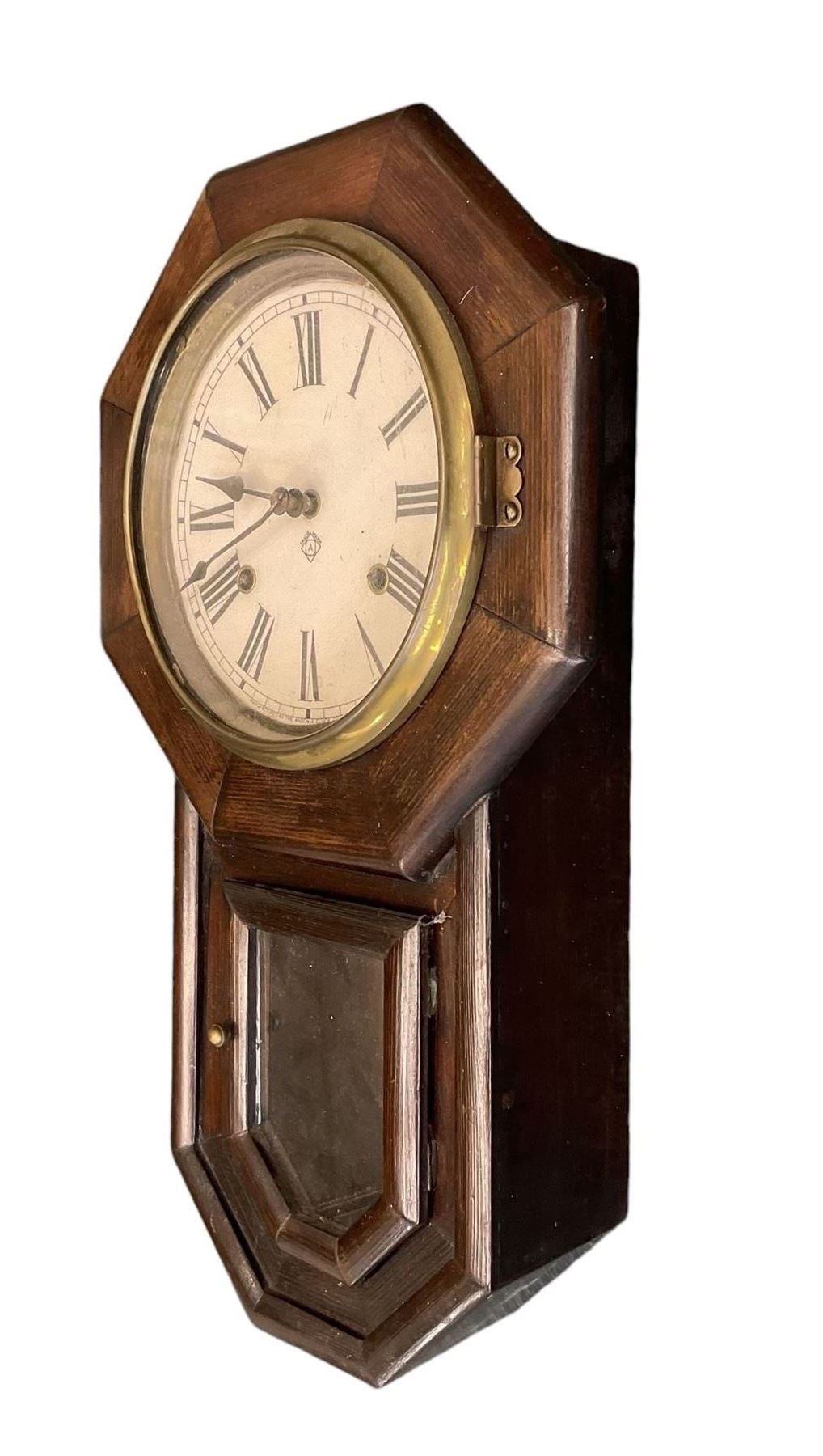 Ansonia- American 8-day oak cased drop dial wall clock with a octagonal dial frame and visible pendulum, striking the hours on a gong.