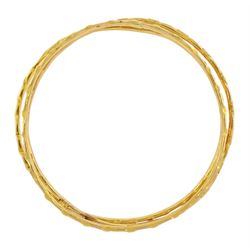 20ct gold Middle Eastern bangle and two similar 19.5ct gold bangles